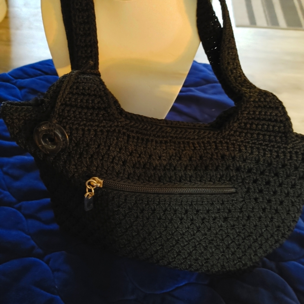 A Purse by Sax. Tightly woven crochet black shoulder Purse.